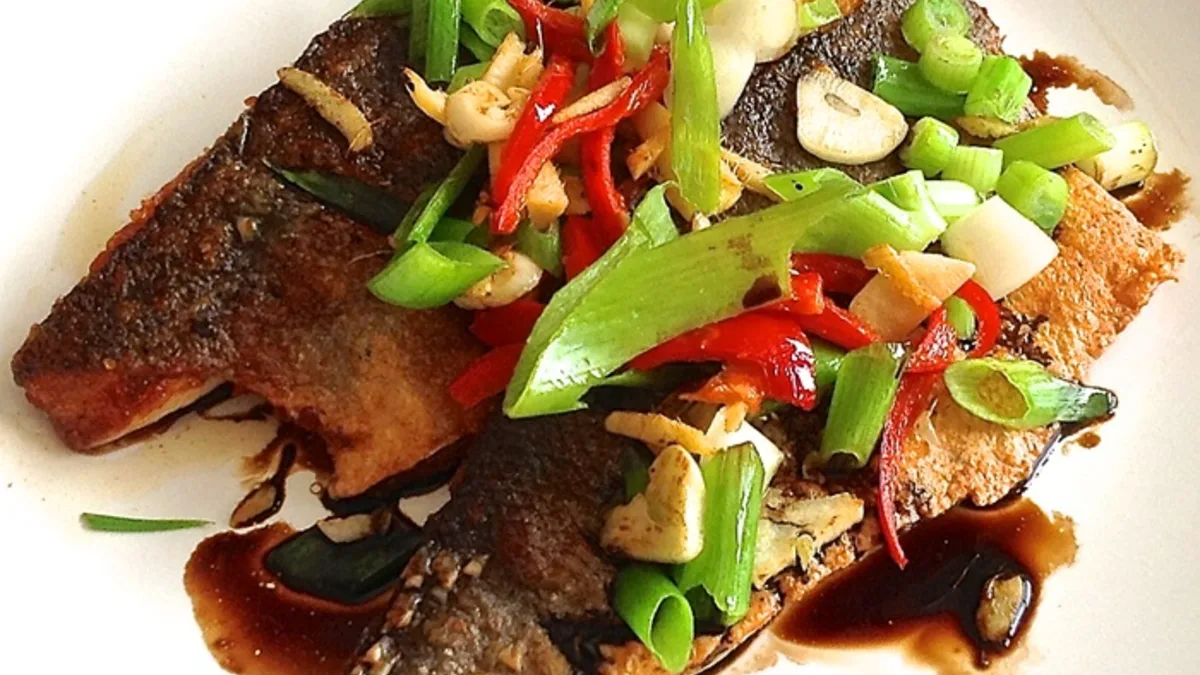 Sea bass with sizzled ginger, chilli & spring onions